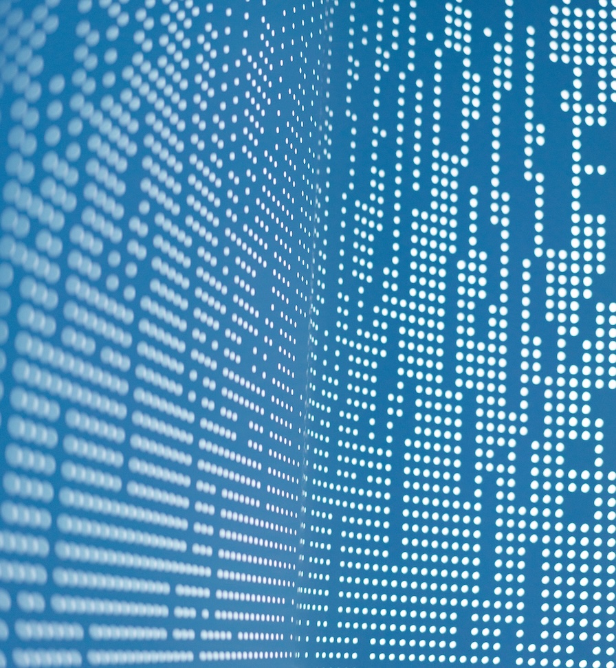 Extreme closeup of a blue monitor screen with white dots